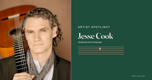 Jesse Cook, new flamenco guitarist and composer, holding his guitar. Photo by Allen Clark.